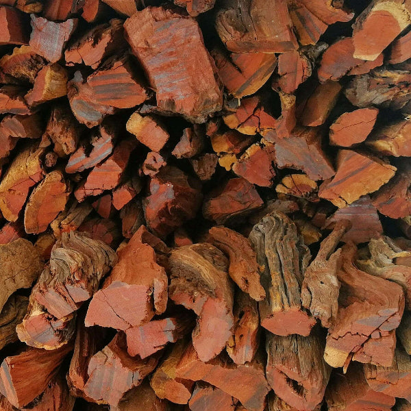 Close-up of Kameeldoring firewood with dense red grain and solid structure